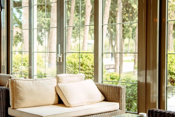 outdoor sofa with beige cushions and coffee table in front of the restaurant window